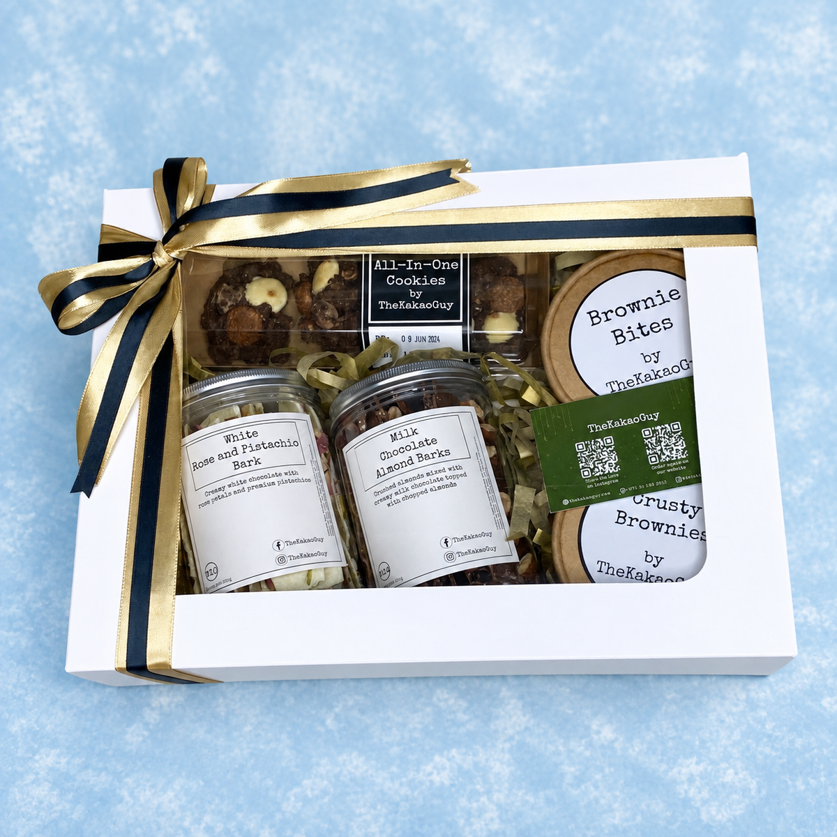 The large celebration hamper by The Kakao Guy offers a select of premium and exclusive sweet goodies. Perfect for special occasions and group gatherings! Contains a selection of chocolate barks, brownies, and cookies.